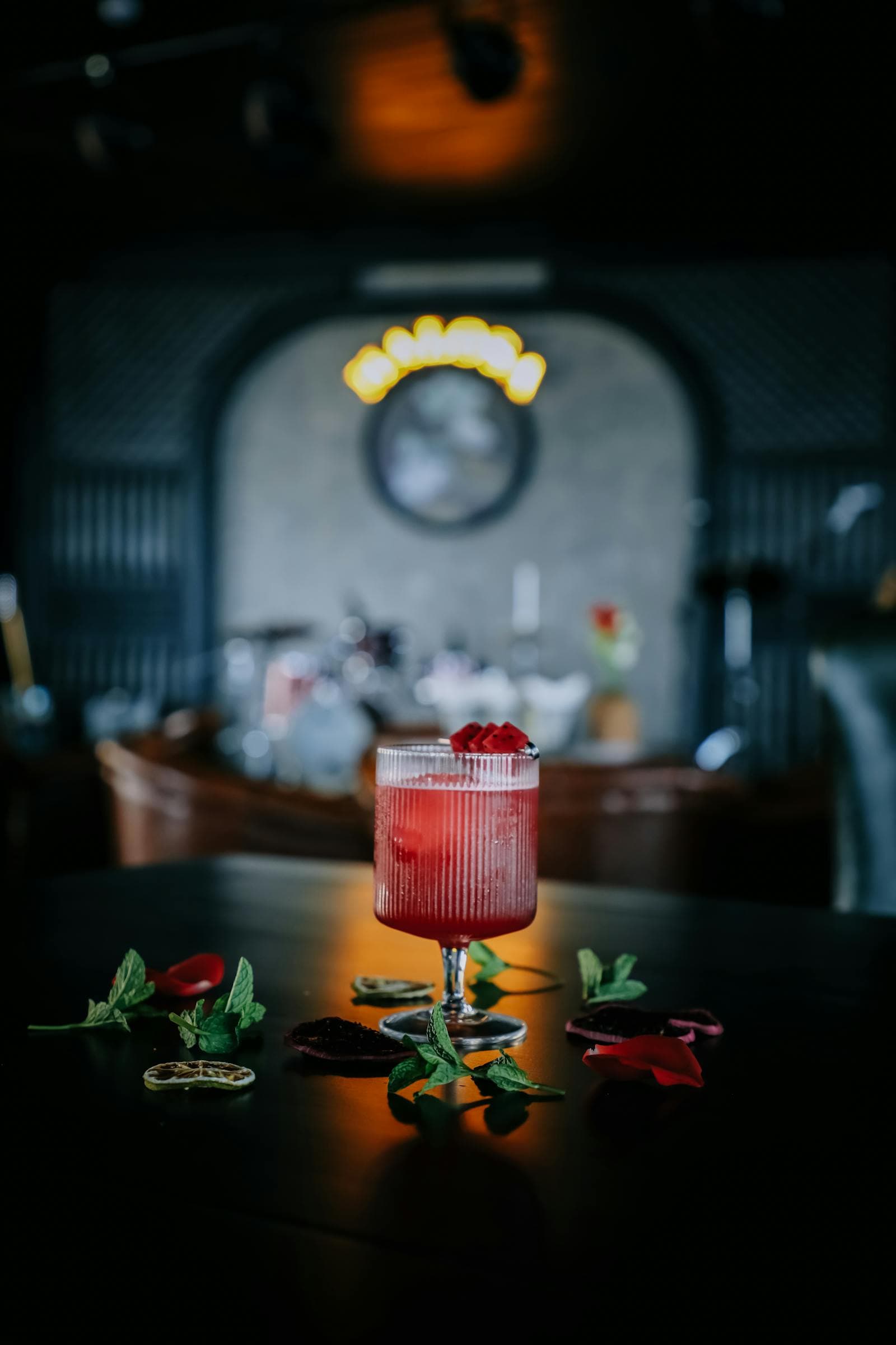A garnished cocktail under low nightclub lighting.